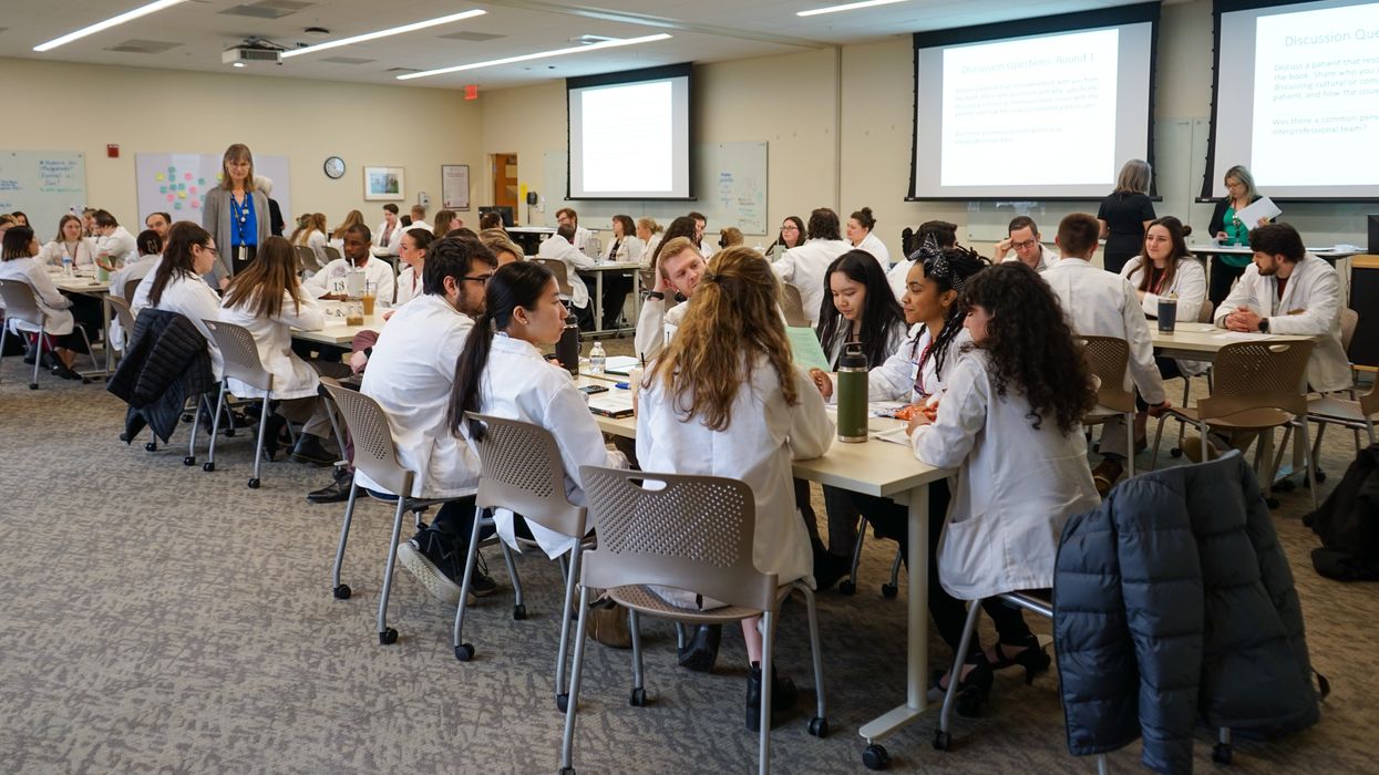 Students sitting at tables in a room.