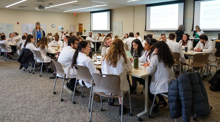 Students sitting at tables in a room.