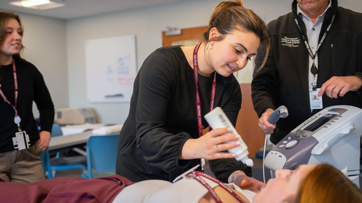 Female OT student with faculty. 