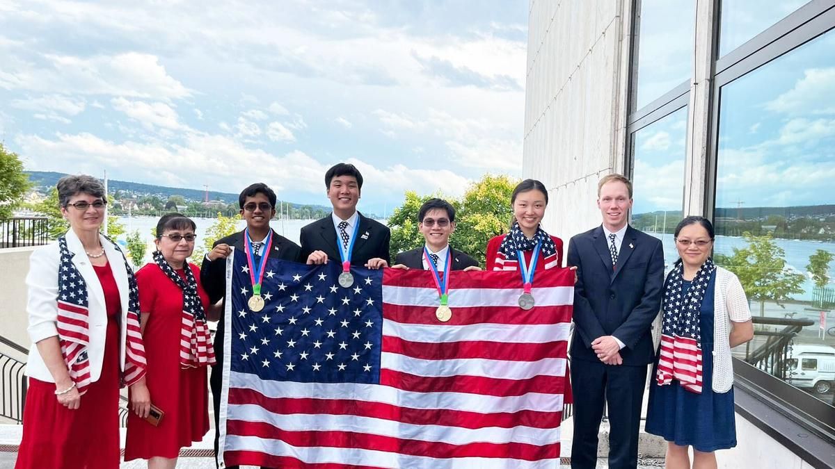 Scientists standing in front of American Flag.