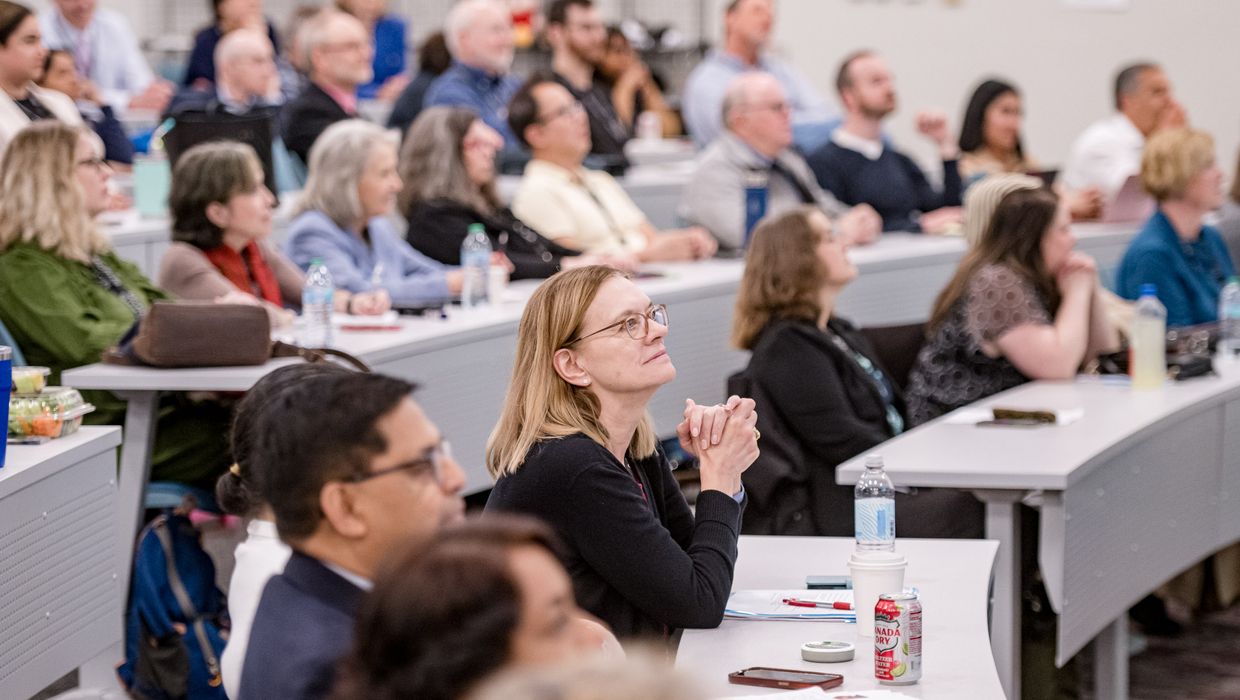 MCPHS faculty sit in a classroom where they were recognized for their achievements during the University’s annual Faculty Day.