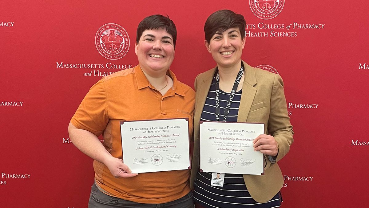 Cathy and Lisa Tagliari holding MCPHS Scholarship Awards.