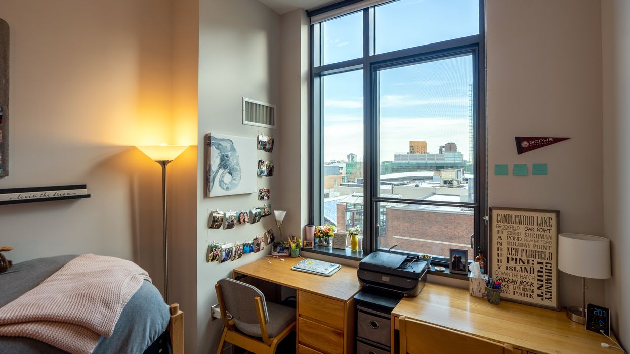 Inside of dorm window showing a bed with stuffed animals on top. .jpg