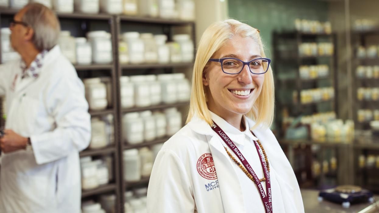 Smiling Acupuncture student in the Chinese Herbal Medicine Dispensary. 