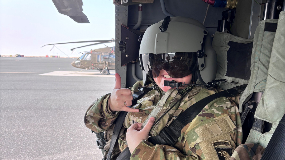 Captain Amanda Woods sits in a helicopter.