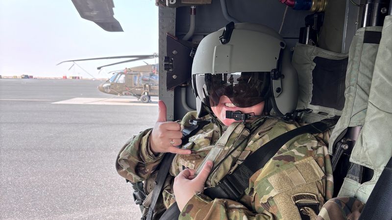 Captain Amanda Woods sits in a helicopter.