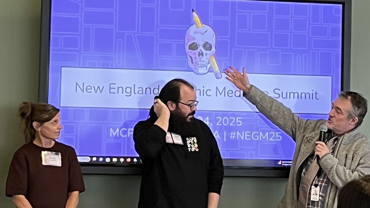 A. David Lewis points to a screen.