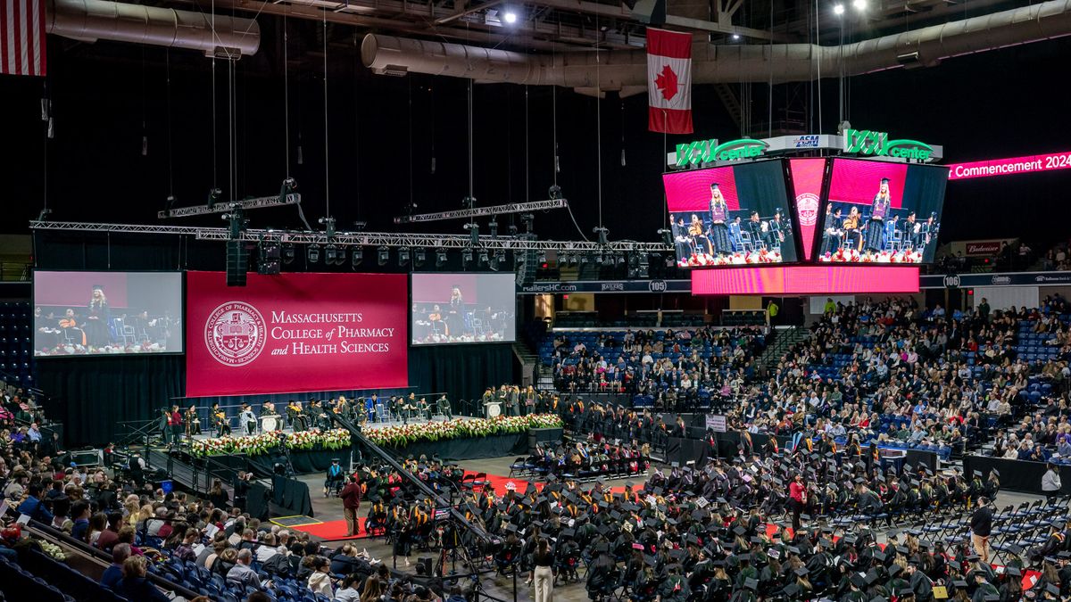 Students in cap and gowns at Commencement. 