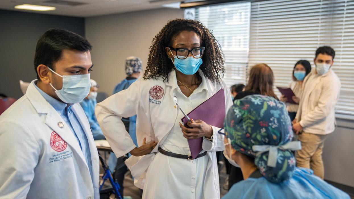 MCPHS students from the pharmacy and dental programs collaborate during an interprofessional education initiative, offering comprehensive exams to older adults in underserved communities. (Ian MacLellan photo)