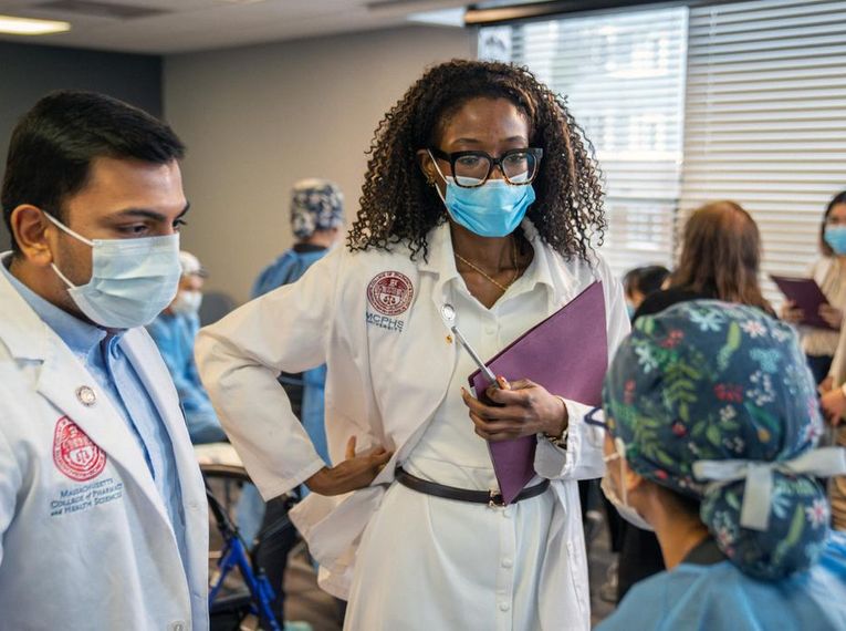 MCPHS students from the pharmacy and dental programs collaborate during an interprofessional education initiative, offering comprehensive exams to older adults in underserved communities. (Ian MacLellan photo)