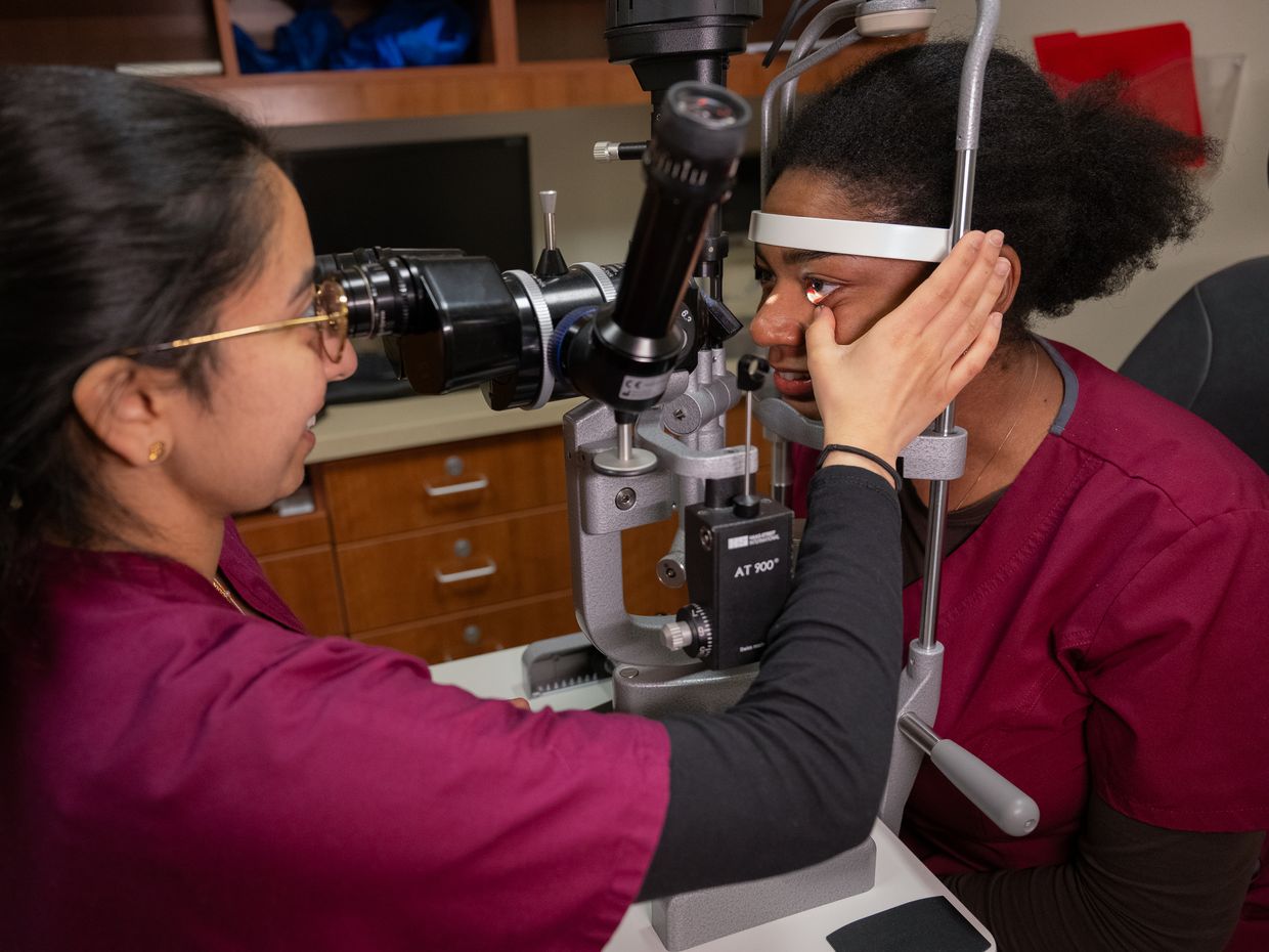 Optometry students on the MCPHS Worcester Campus collaborating and using different optometry tools and equipment.