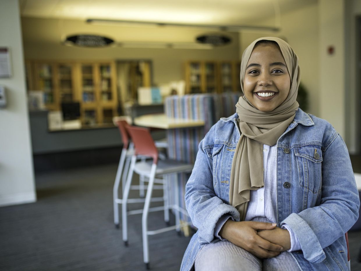 Smiling female student in the library.