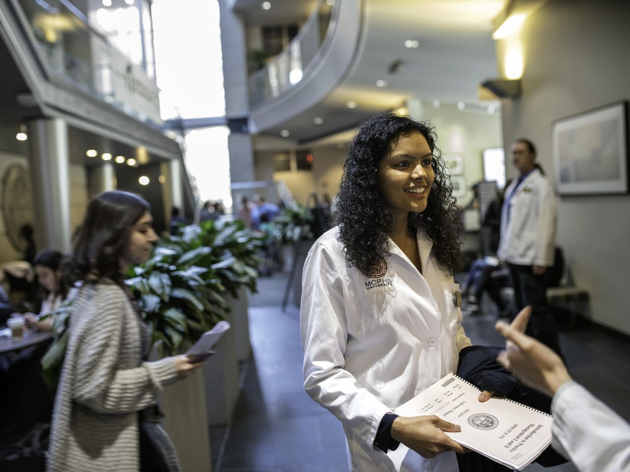  female student in a lab coat. 