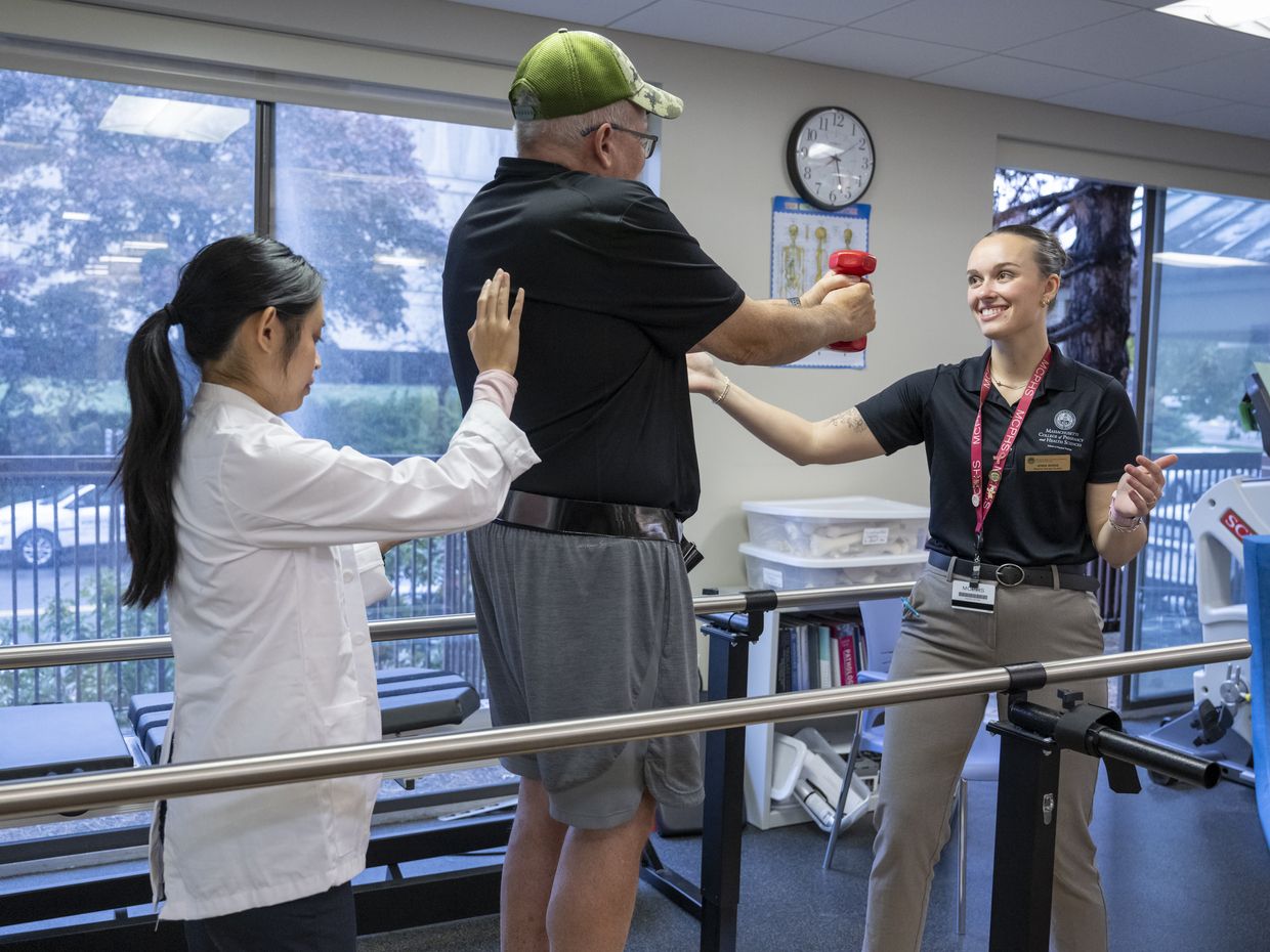 Physical Therapy students working with patients in lab setting