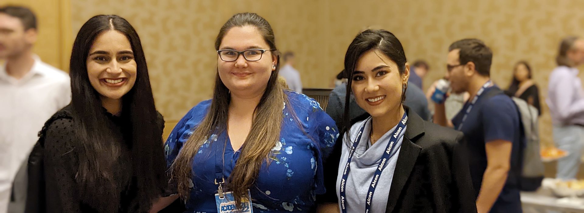 Optometry alumni smiling at an event. 