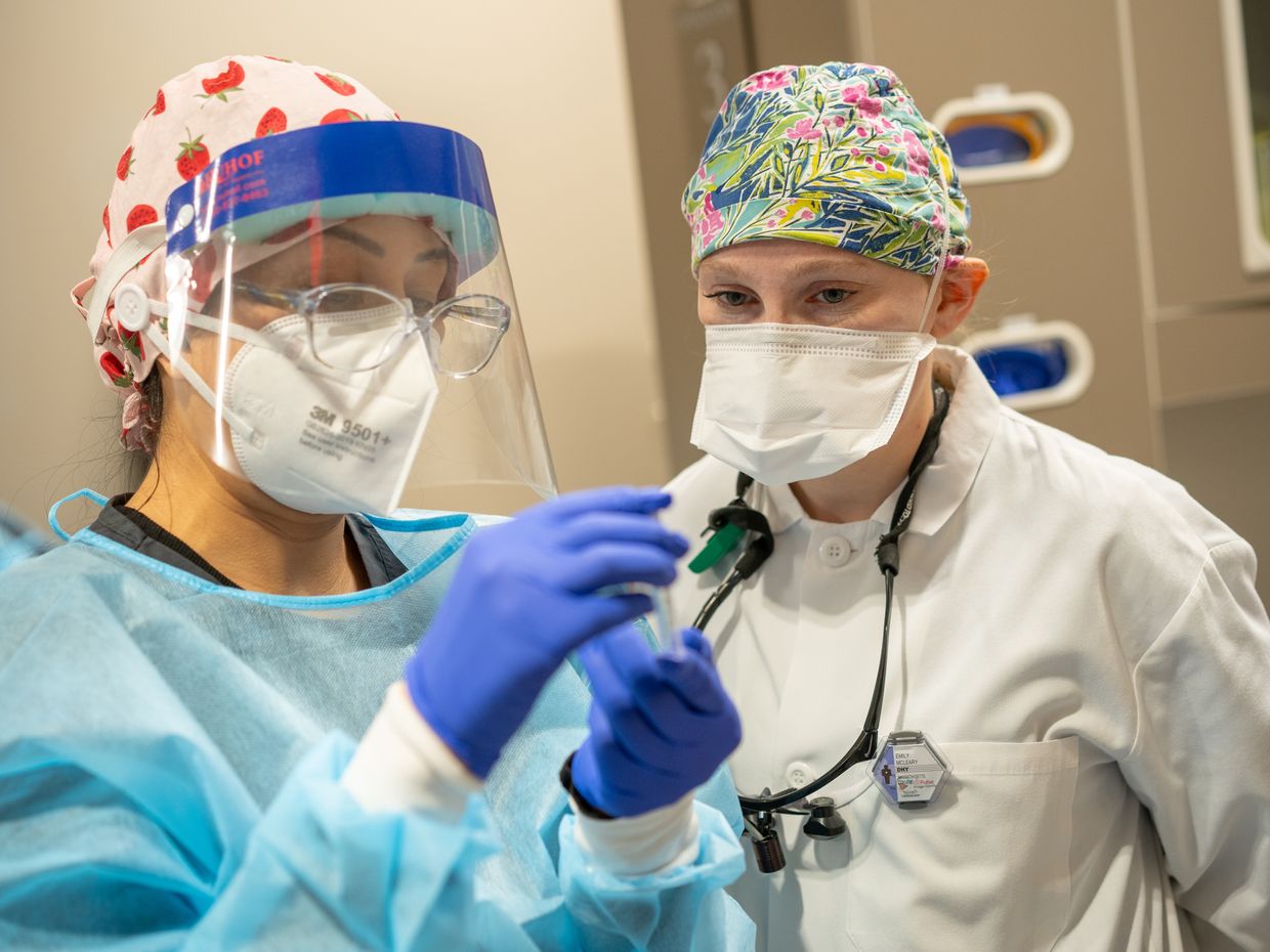 Dental Hygiene student and professor wearing surgical masks and gloves in the Dental Hygiene Clinic. 
