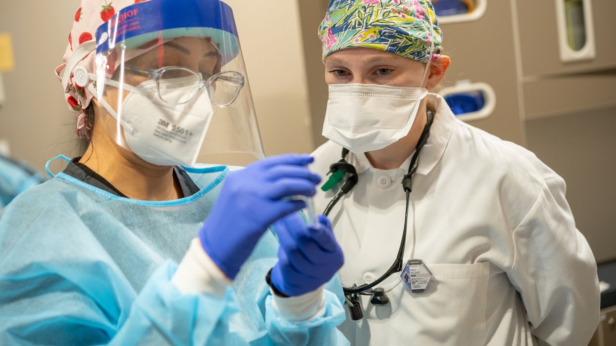 Dental Hygiene student and professor wearing surgical masks and gloves in the Dental Hygiene Clinic. 