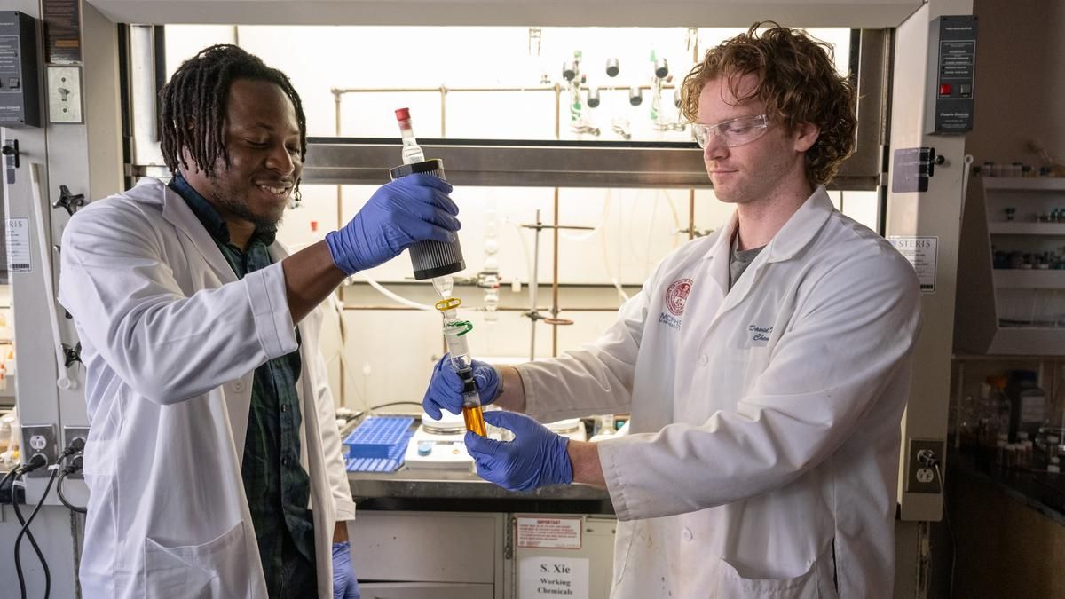 Two male students working in the Boston lab