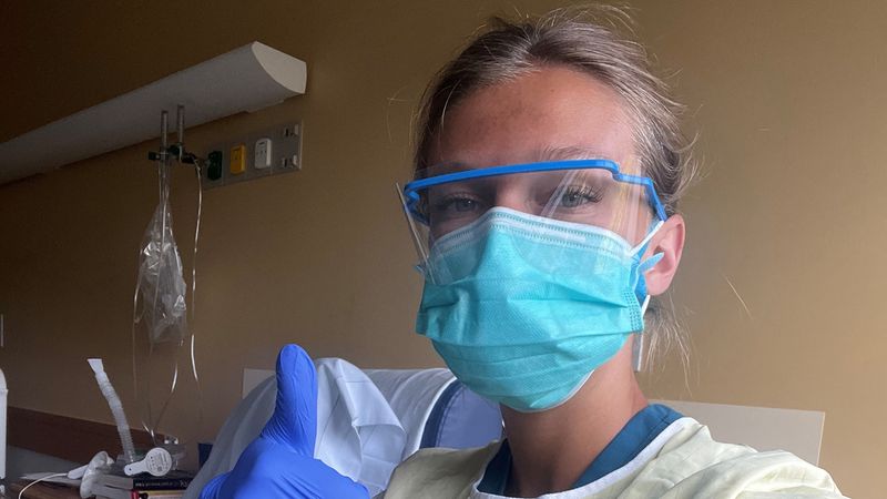 Abbie McCaffrey, MSOT '22, wears personal protective equipment including goggles, a face mask, and gloves while working as an inpatient hospital occupational therapist.