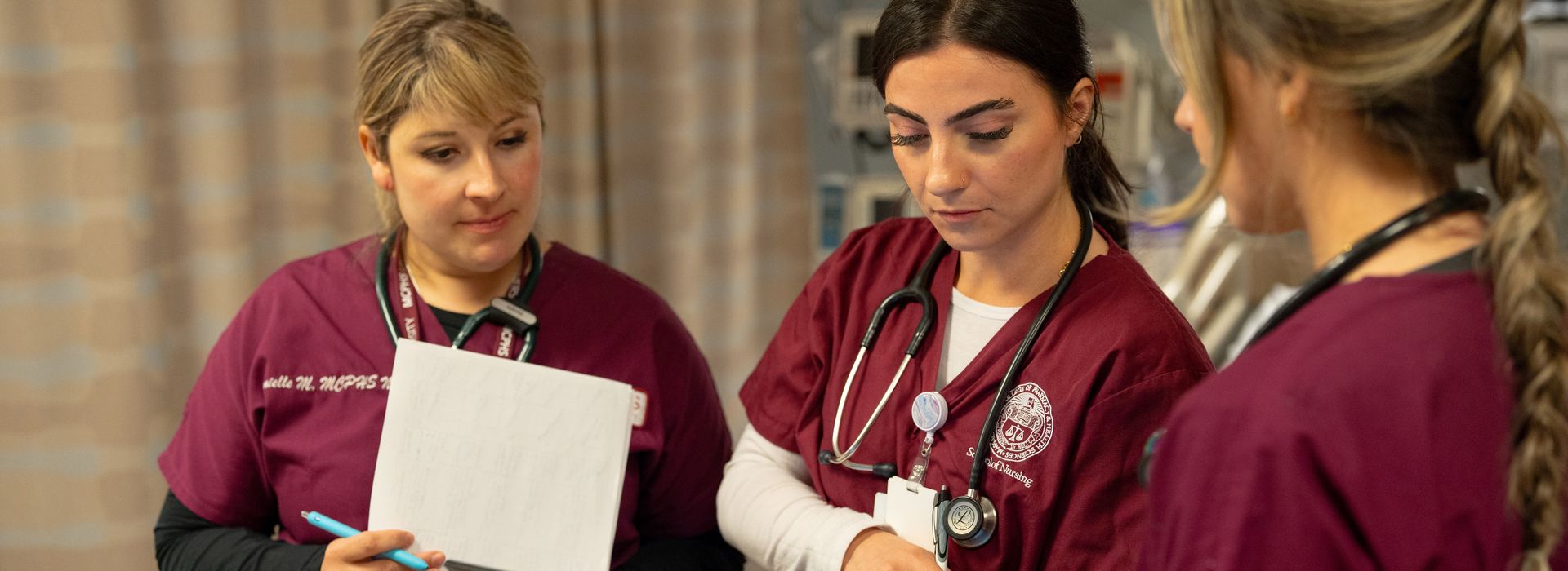 Female student in scrubs.