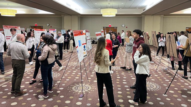 Students stand at the MCPHS Worcester/Manchester Research & Scholarship Showcase.