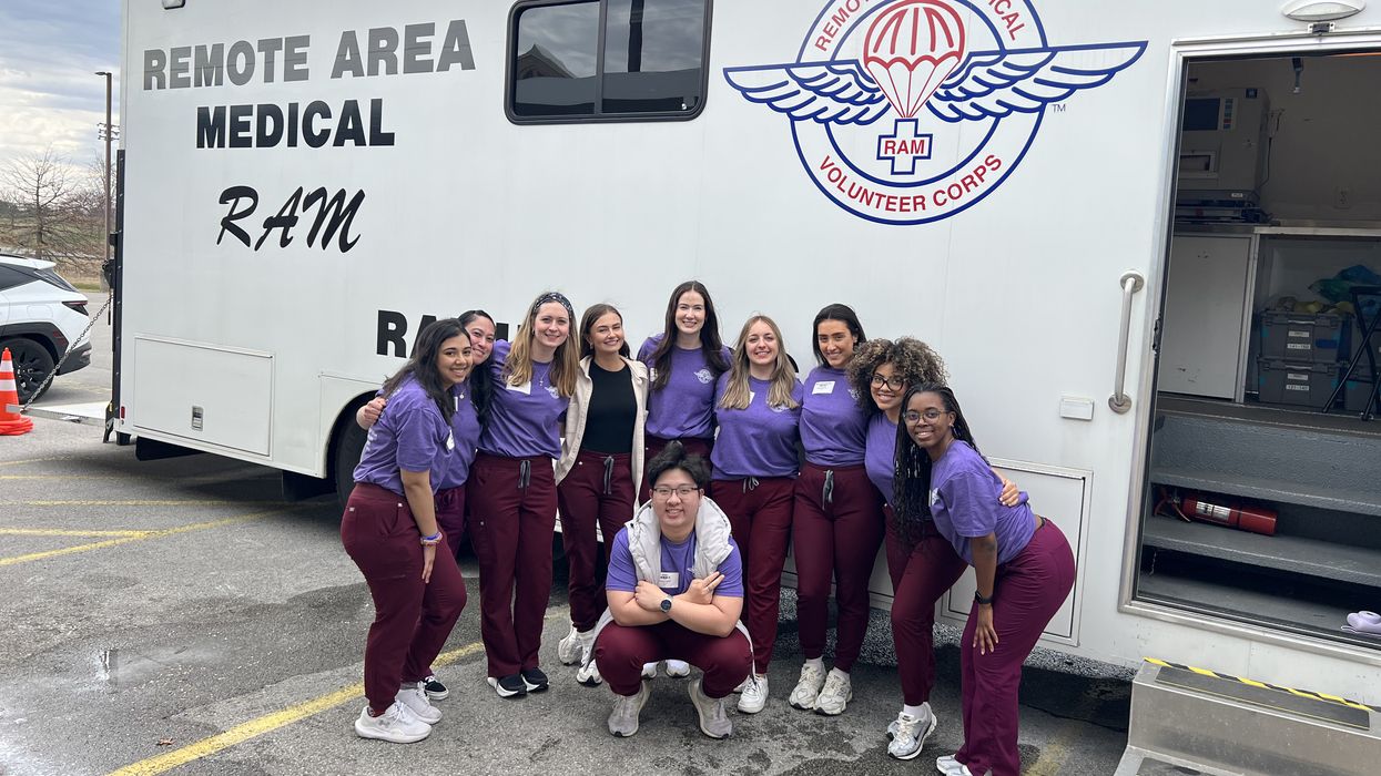 MCPHS Optometry Students standing in front of a van