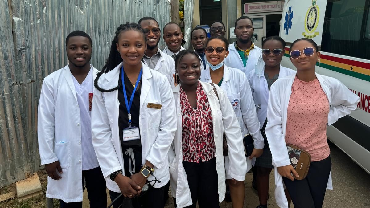 Students standing in front of an ambulance in Ghana.