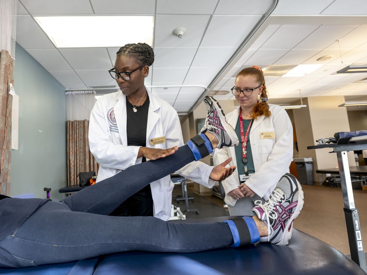 Physical Therapy students working with patients in lab setting