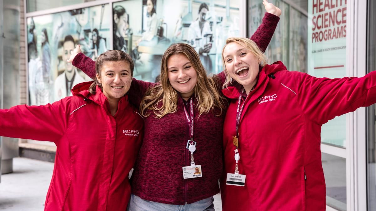 Three female MCPHS students smiling. 