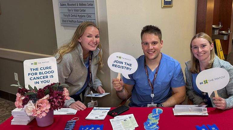 Three MCPHS students at the Stem Cell Donor Registry event.