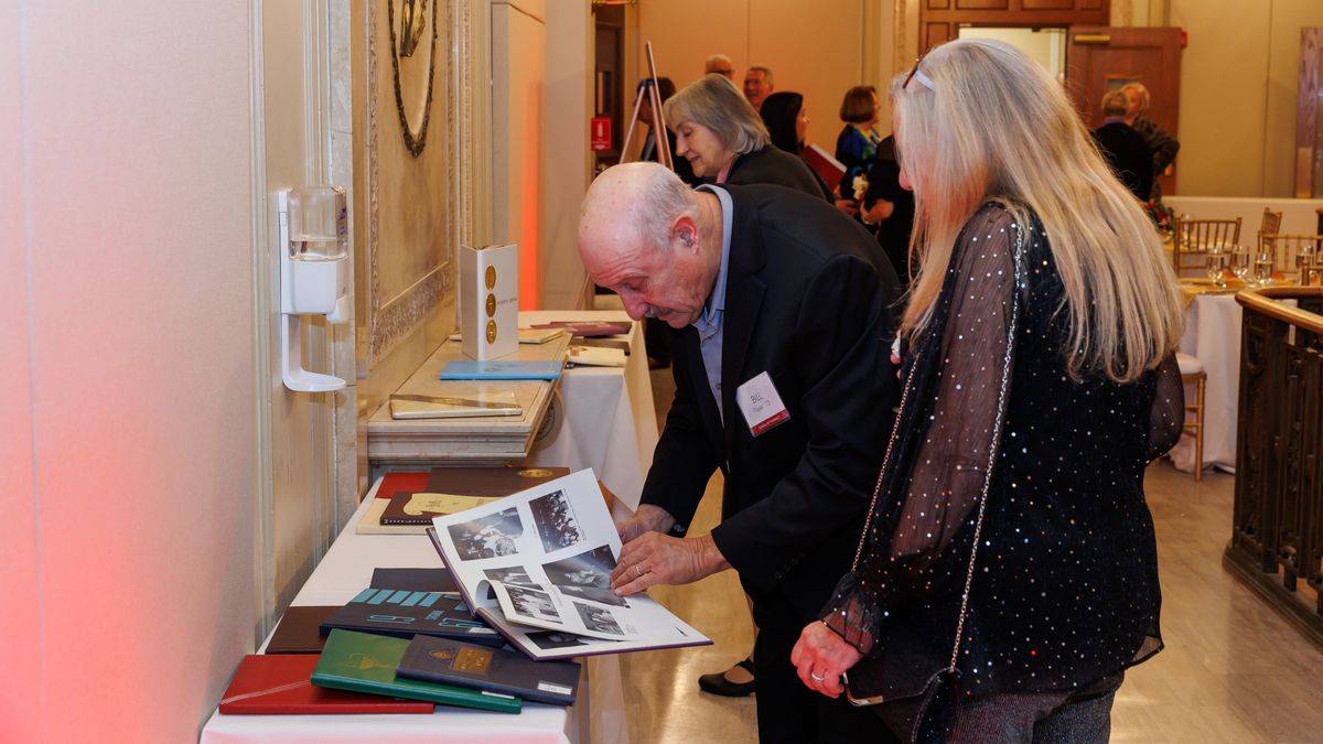 People looking at old yearbooks.