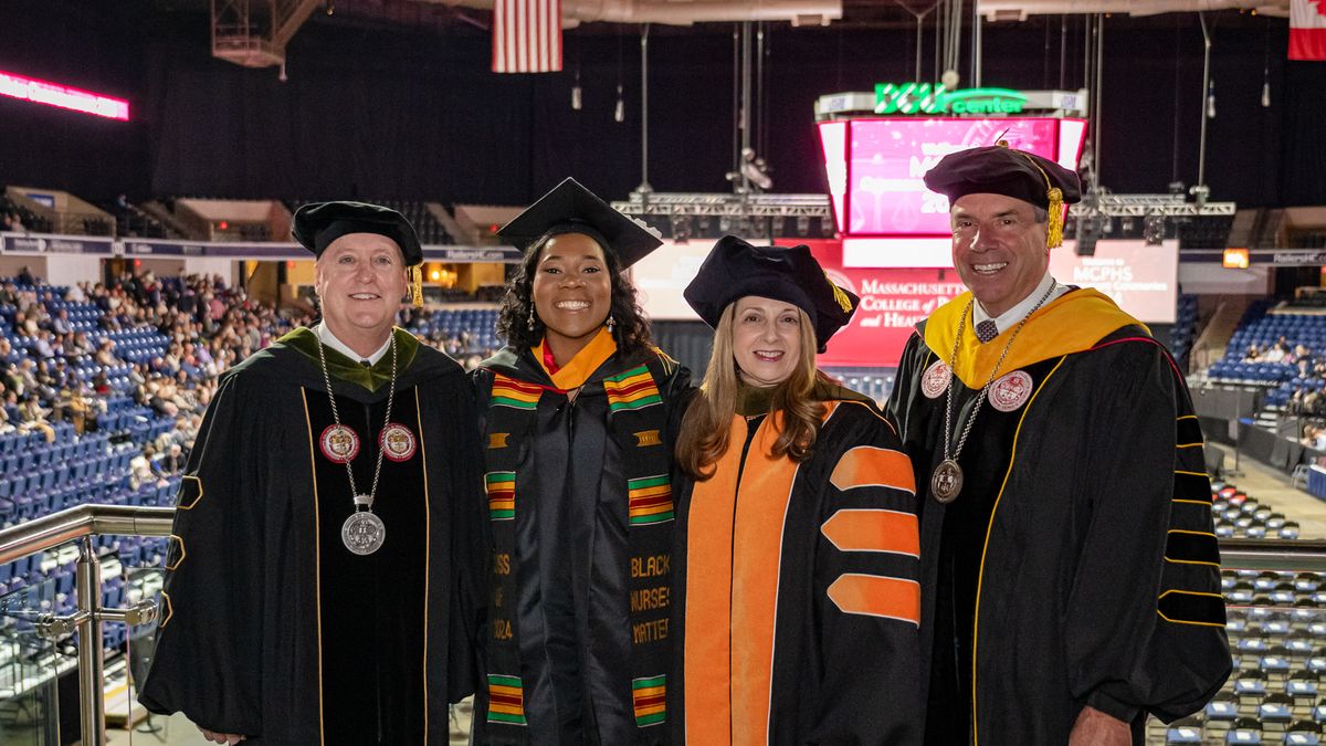 Students in cap and gowns at Commencement. 