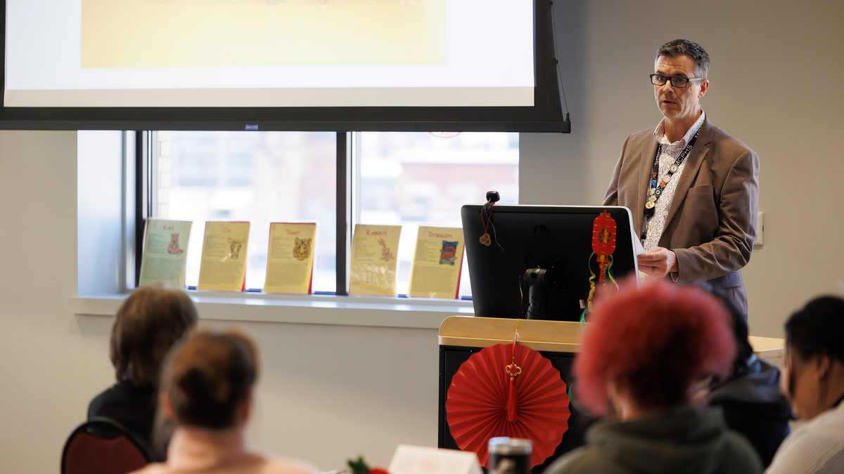 Dennis Moseman addresses people from a podium.