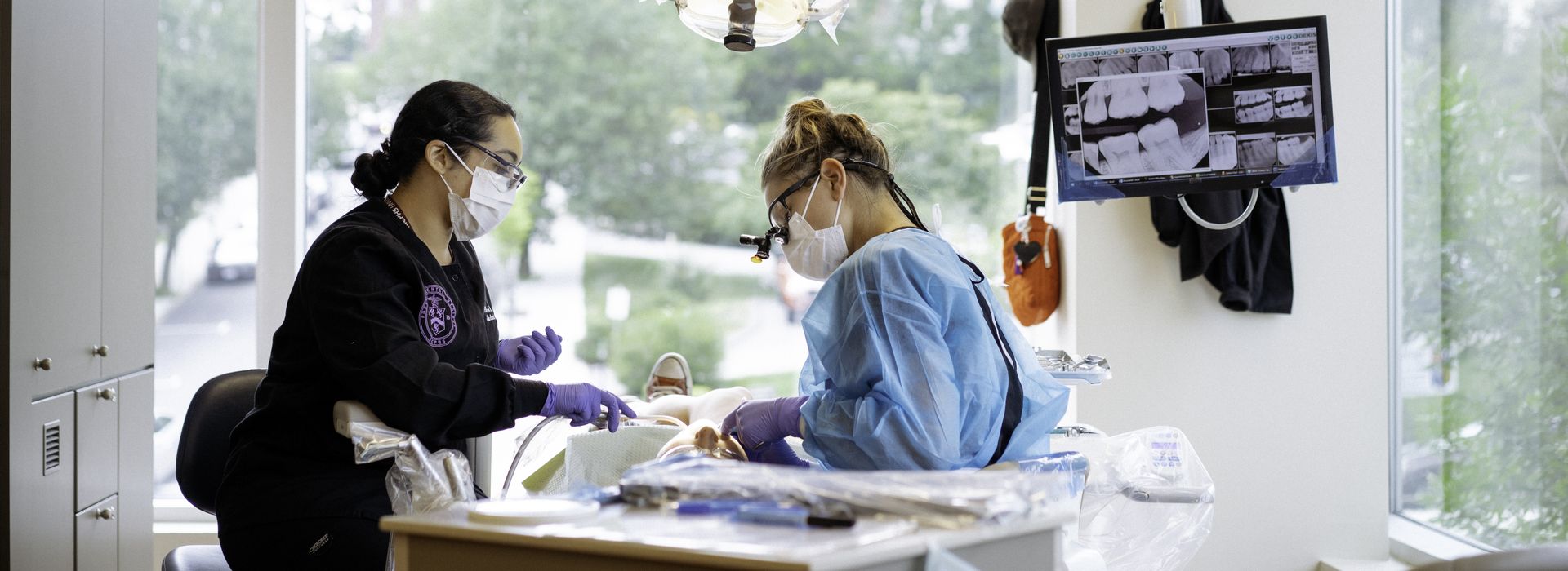 Two MCPHS Dental Hygiene students working in the Forsyth Dental Hygiene Clinic.