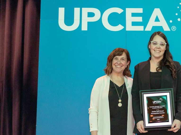 Amber Palmer from the School of Professional Studies accepts the UPCEA award