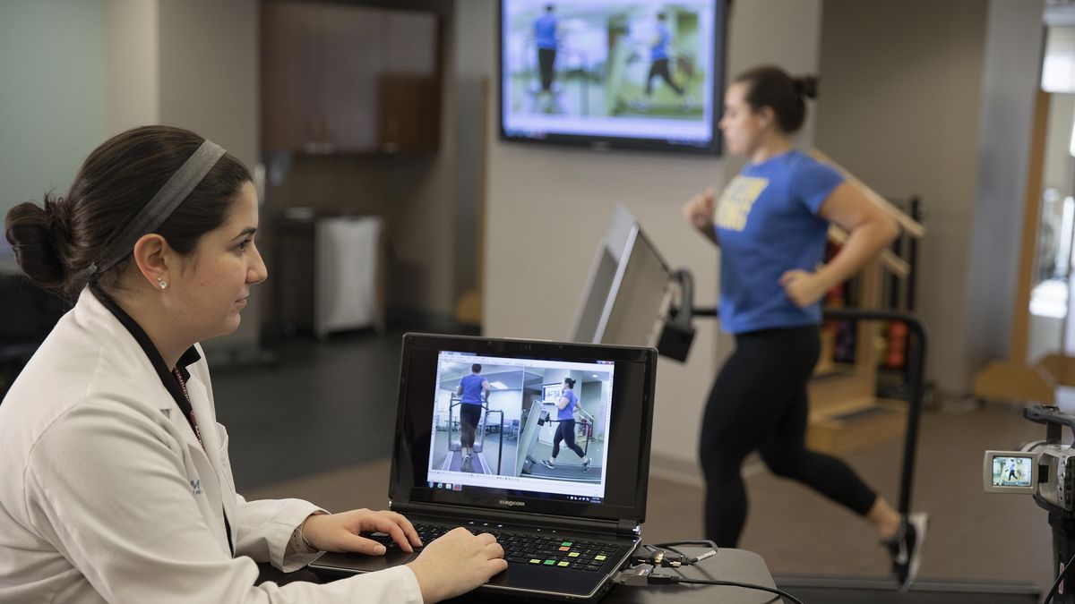 Physical Therapy student watching a patient run on a treadmill. 