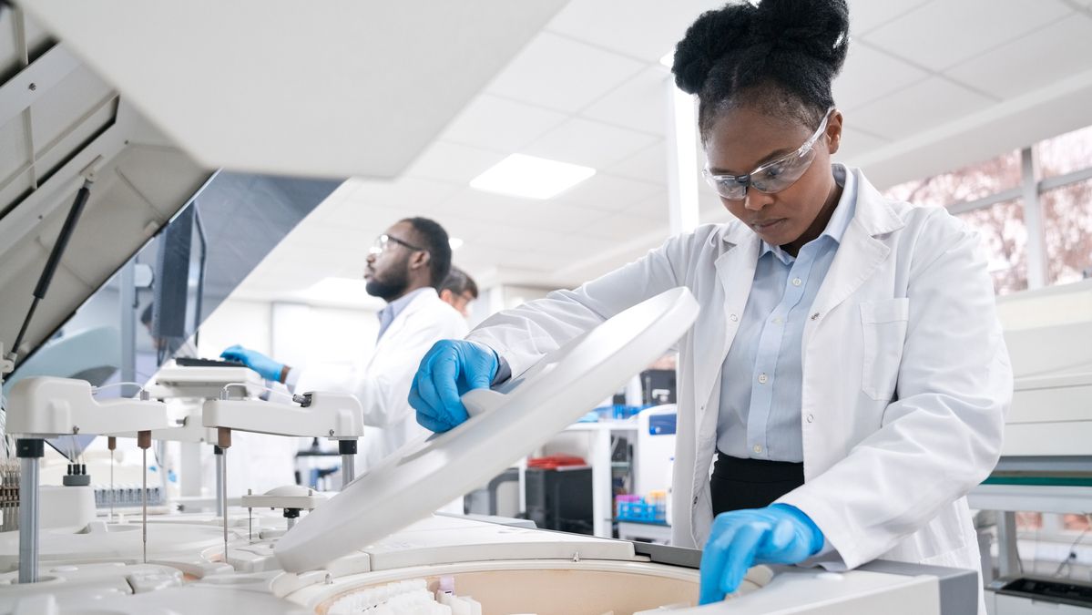 Female medical worker wearing lab coat while working in laboratoryFemale medical worker wearing lab coat while working in laboratory