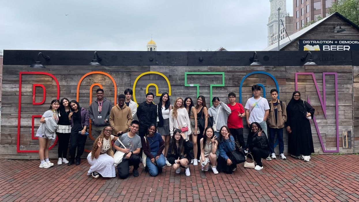 MCPHS International Students stand in front of Boston sign.