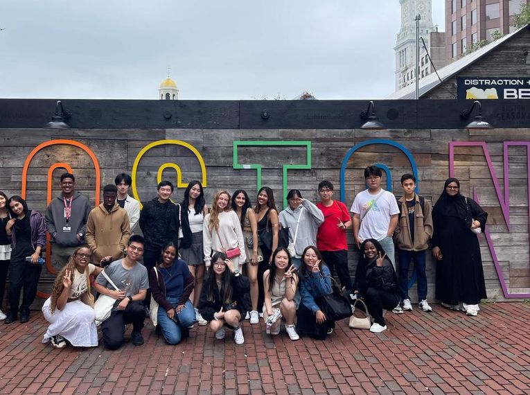 MCPHS International Students stand in front of Boston sign.