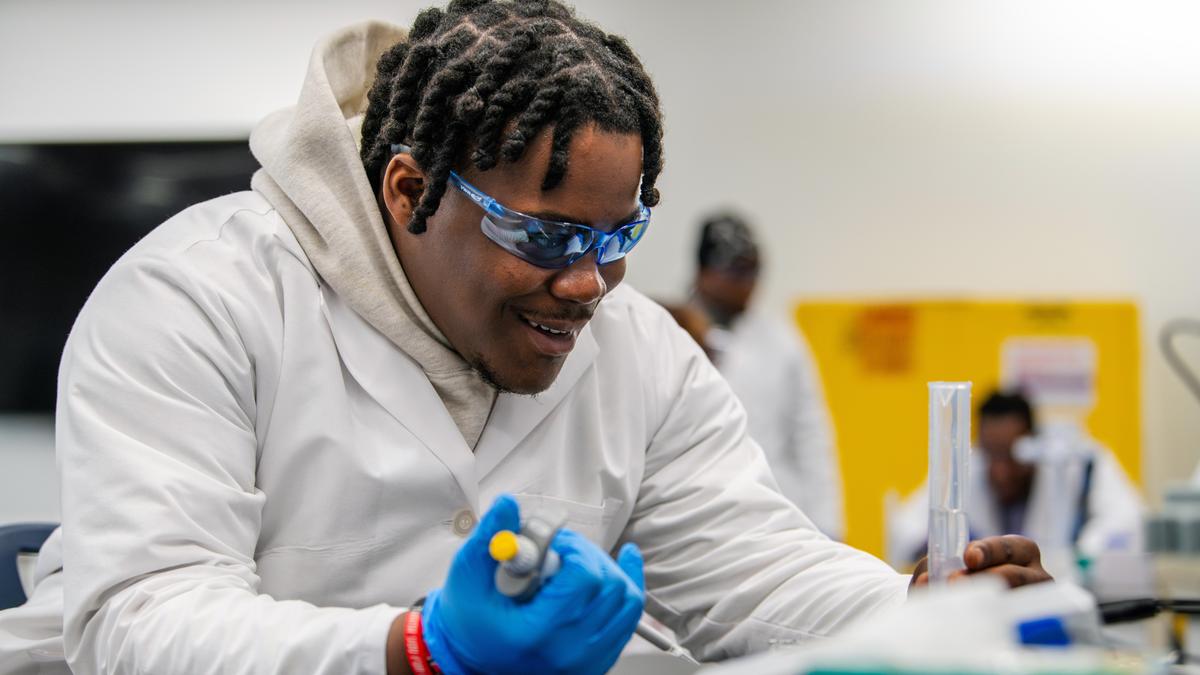 Male student measures volume.