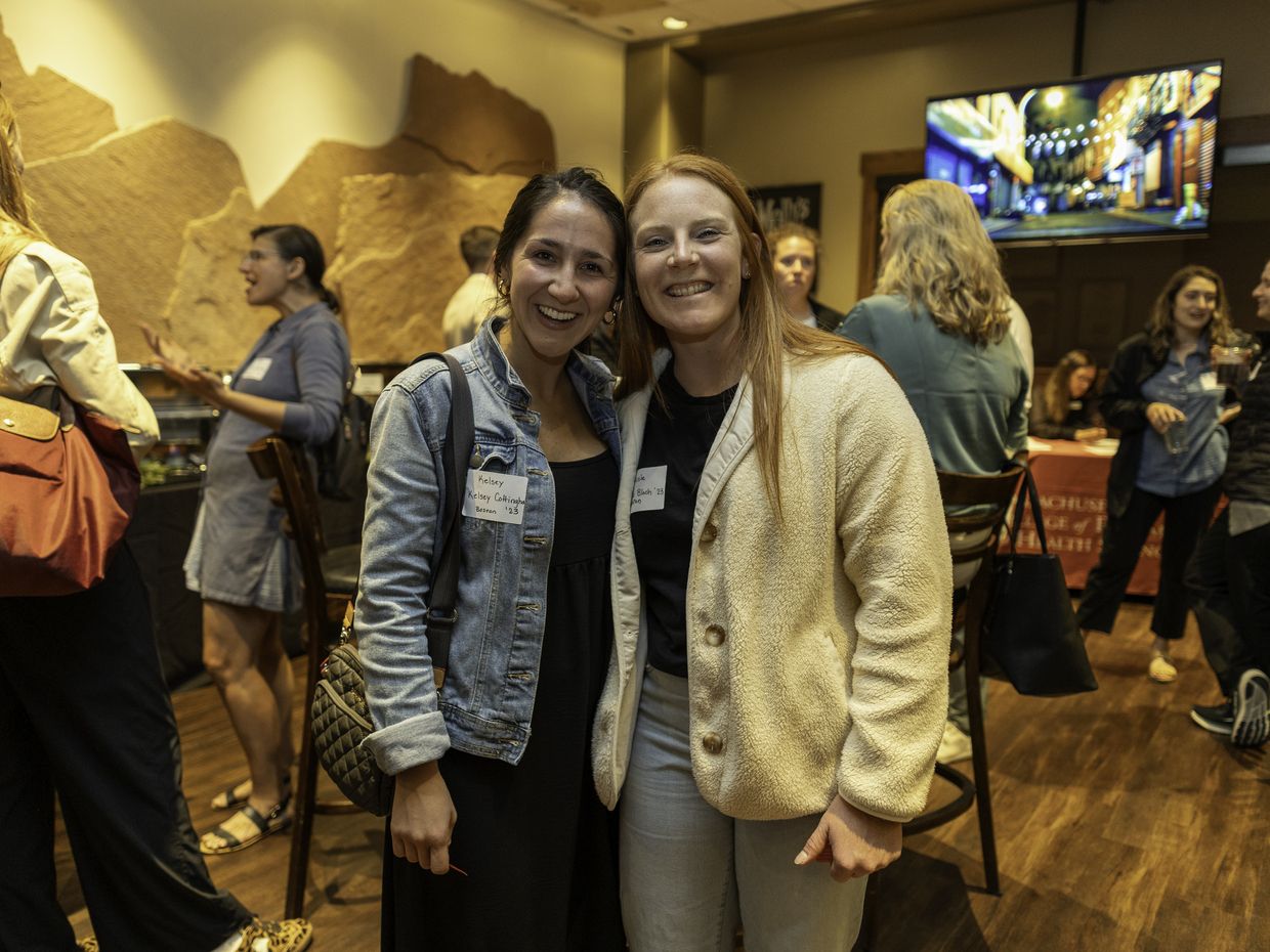 Two alumni smaling at the American Academy of Physician Associates (AAPA) conference.
