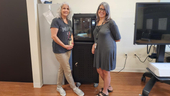 Dr. Michelle Dowling and Dr. Danielle Amero stand in front of a 3D printer.