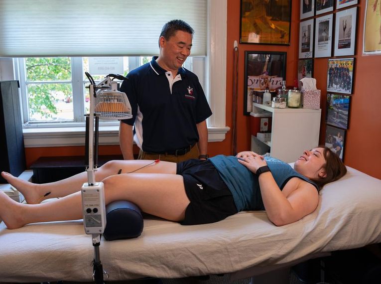 George Leung smiles at patient.