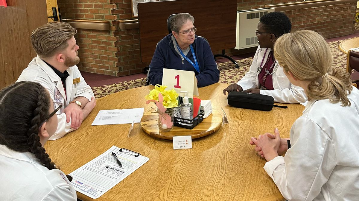 People sit at table talking.