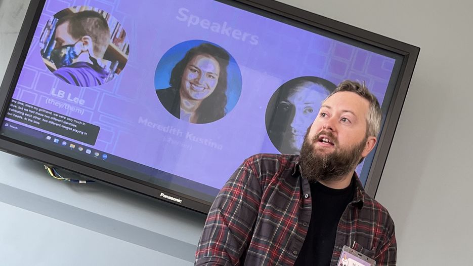Michael Anthony stands in front of a screen.