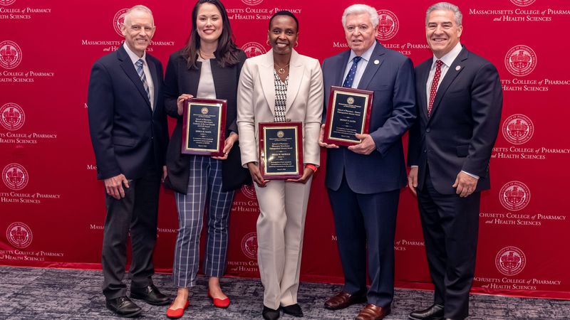 MCPHS Pharmacy Deans and Alumni holding awards at the 202 Reed confernce. 