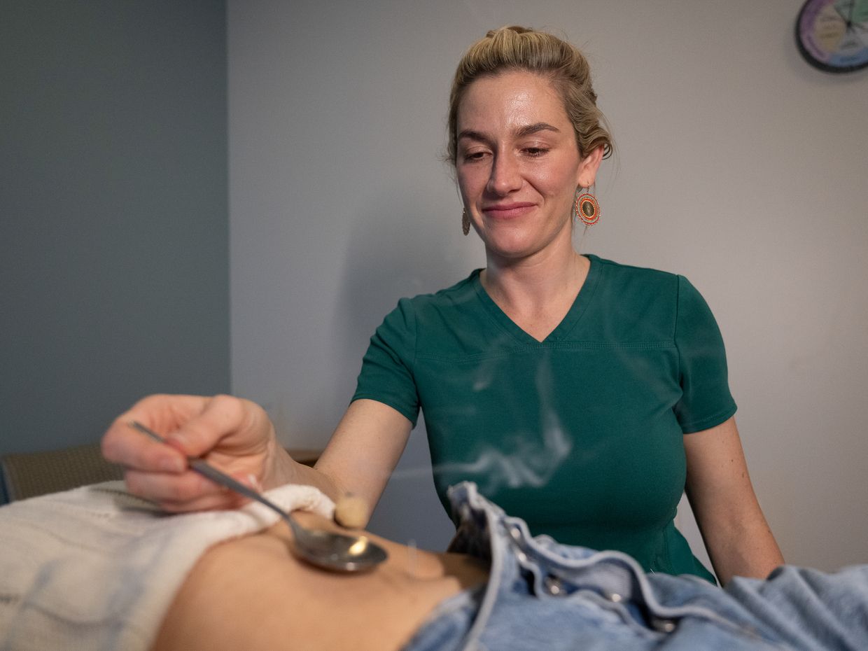 Students and faculty collaborating in the NESA acupuncture clinic on the MCPHS Worcester campus. 