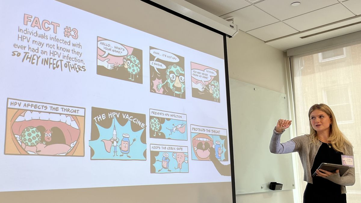 Annika Mengwall points to a screen.