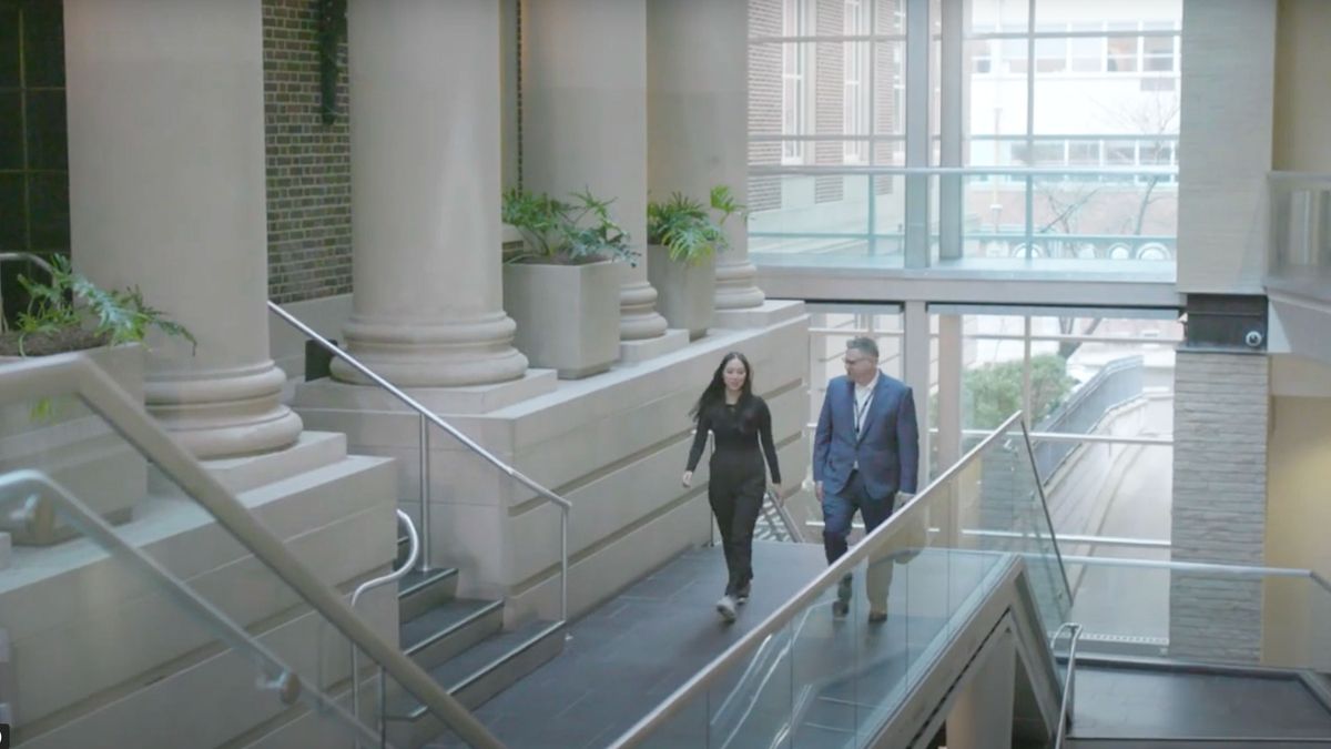 Man and woman walk up stairs at MCPHS.