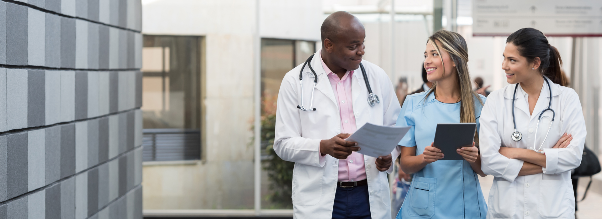 a group of doctors and a nurse walking down a hallway.	